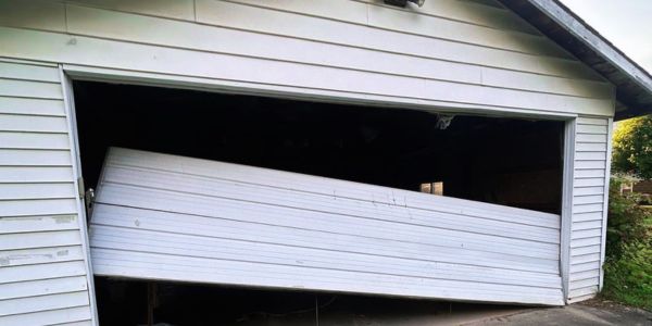 Understanding Off-Track Garage Doors: Causes and Risks